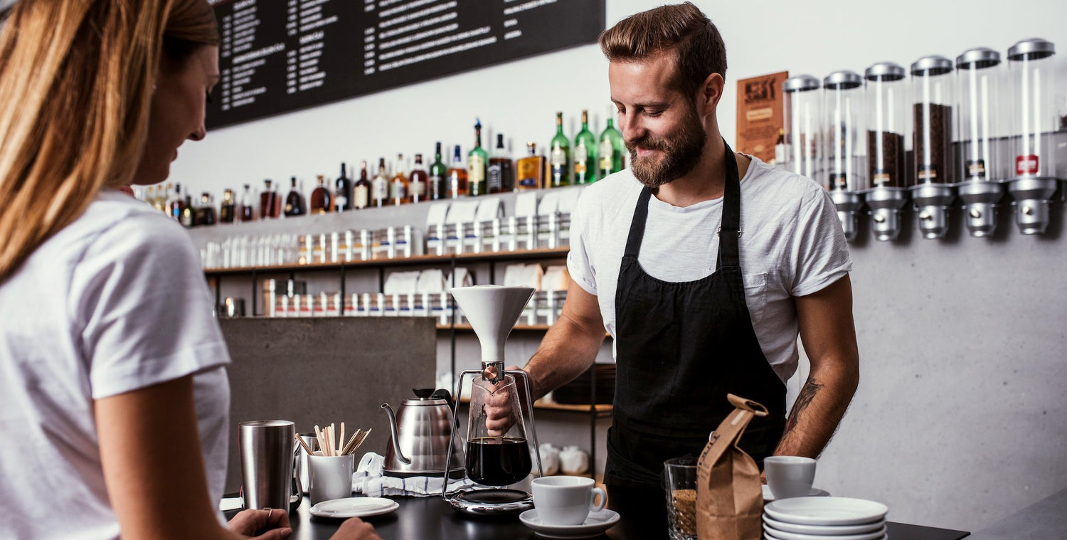 Barista preparing coffee on GINA smart brewing instrument