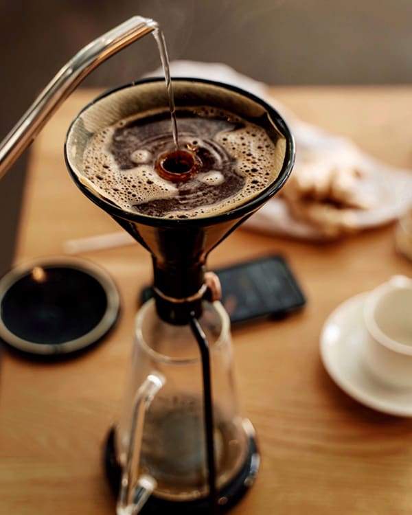 GINA Black coffee brewing inside the funnel in black. Great for immersion coffee, pour over or cold drip